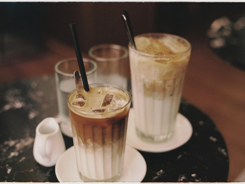 Salvadorans sharing coffee at a local festival, highlighting the cultural significance of coffee.