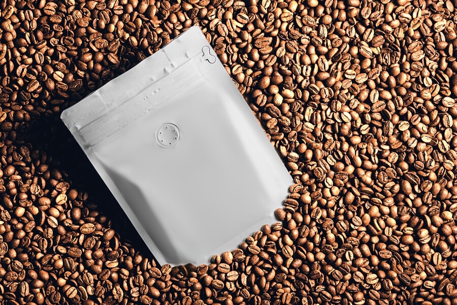 Close-up of a custom coffee bag with one-way degassing valve to preserve freshness and prevent bag swelling.